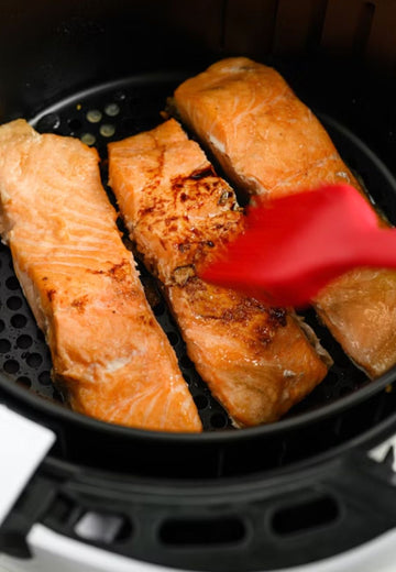 Salmon cooking in pan