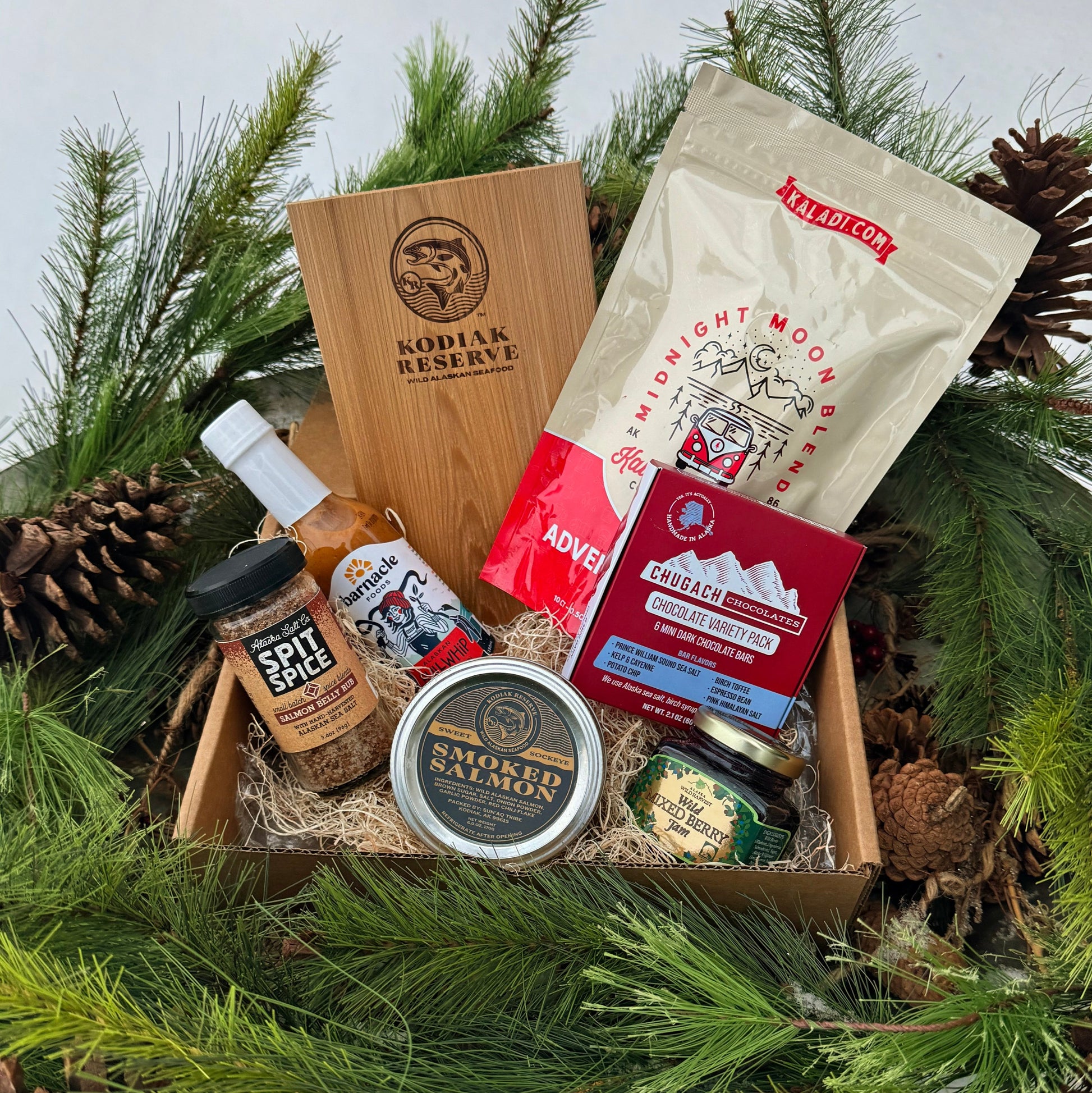Gift box with Kodiak Reserve products surrounded by pine branches and pinecones.